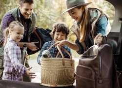 family of four gathered around a picnic basket