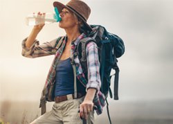 woman drinking from a water bottle