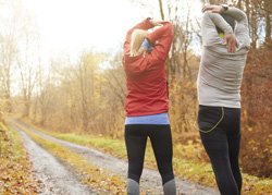 two people stretching before exercising
