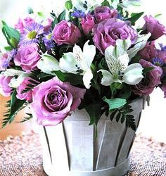 pink roses and white lilies in white wooden basket