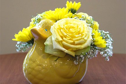 yellow floral arrangement in a duck