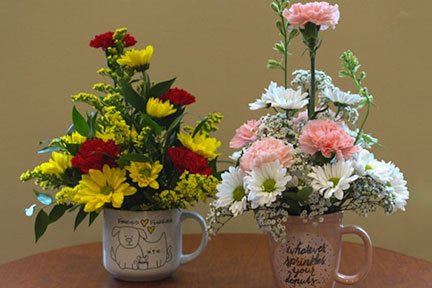 assorted flowers in a pink or blue mug