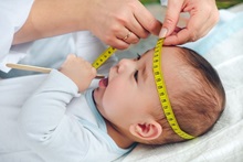 doctor measuring a babies head